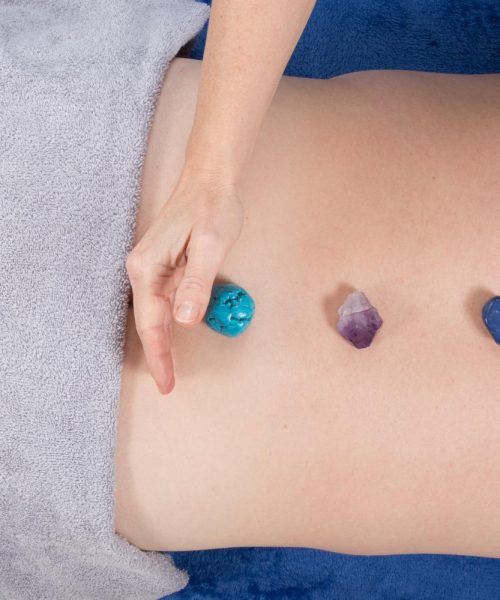 man-receiving-stone-therapy-reiki-massage-top-view