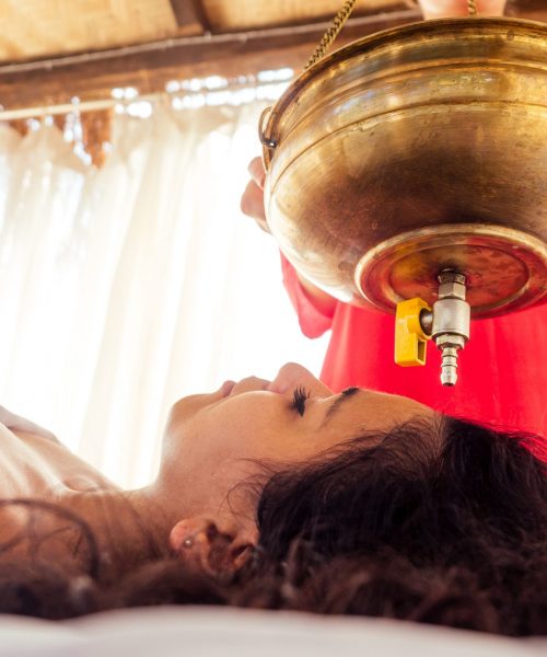 young woman doing healthcare indian traditional treatment in Ayurveda body constitution centre.